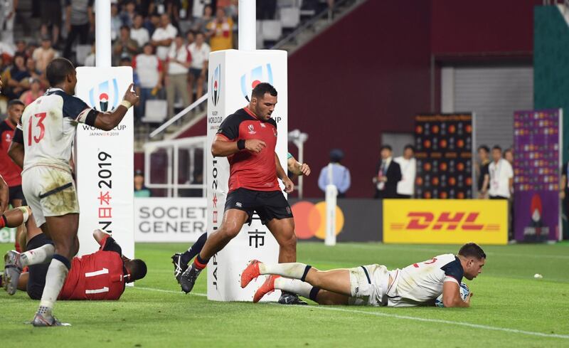 Bryce Campbell of the US scores their first try against England at the Kobe Misaki Stadium. Reuters