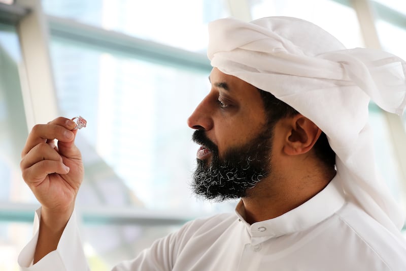 Ahmed Bin Sulayem, executive chairman and chief executive of DMCC, inspects the gemstone. 