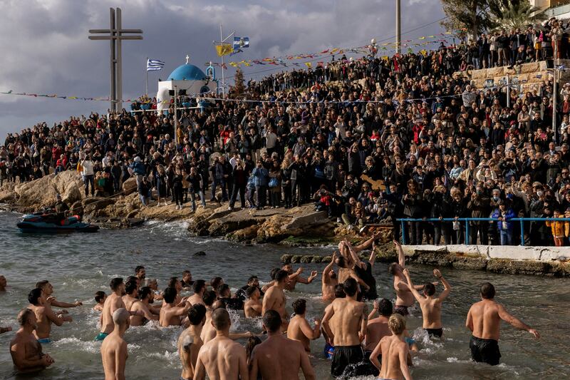 Orthodox faithful jump to catch a wooden crucifix during Epiphany day celebrations in Piraeus, Greece. Reuters