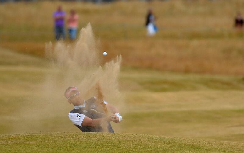 Ian Poulter of England hits out of a bunker on the 15th hole
 during the final round of the British Open golf Championship at Muirfield in Scotland July 21, 2013. REUTERS/Toby Melville (BRITAIN  - Tags: SPORT GOLF)   *** Local Caption ***  LON756_GOLF-OPEN-_0721_11.JPG