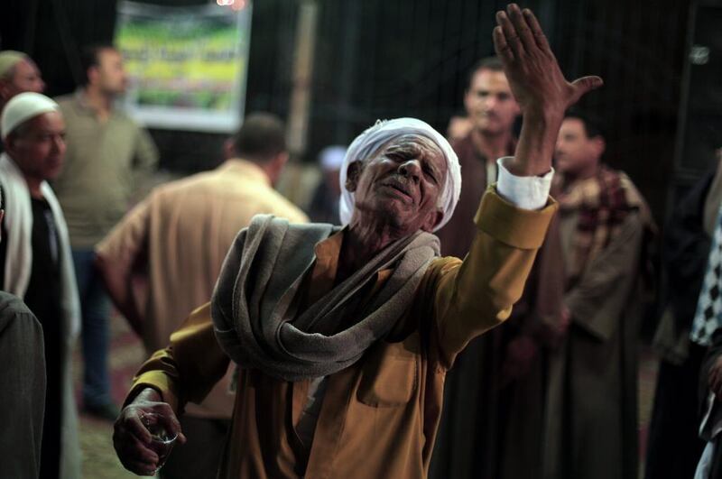 An elderly Egyptian man performs ritual dance in a ‘zikr’ tent as they celebrate Moulid at the Sayyeda Zeinab shrine in Cairo, Egypt. Khalil Hamra / AP Photo
