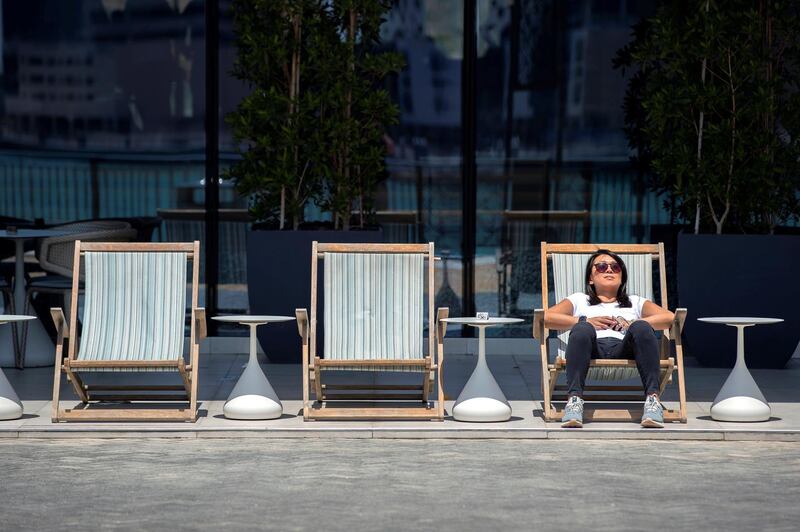 Dubai, United Arab Emirates - April 25, 2019: A women enjoys the sunny but cool weather on Dubai Creek. Thursday the 25th of April 2019. Business Bay, Dubai. Chris Whiteoak / The National