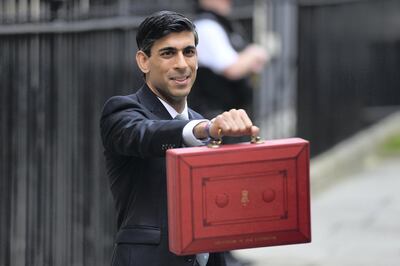 LONDON, ENGLAND - MARCH 11: Chancellor of the Exchequer, Rishi Sunak holds up the Budget box as he presents the annual Budget at Downing Street on March 11, 2020 in London, England. The government is presenting its first budget amid the economic pressure of the coronavirus outbreak. Earlier today, the Bank of England announced an emergency interest-rate cut to boost economic activity. (Photo by Peter Summers/Getty Images)