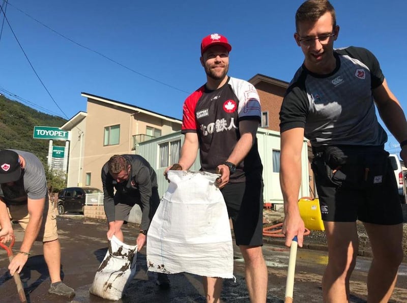 Handout photo taken with permission from the Twitter feed of members of the Canadian rugby team, whose match against Namibia was cancelled, helping to clear roads after typhoon Hagibis saw torrential rain and tornado-like winds hit large parts of Japan. PA Photo