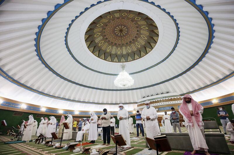 Muslim men pray at Fatmah Mosque in Kuwait city just before daybreak, during Laylat al-Qadr, which falls on the 27th day of the holy month of Ramadan. Laylat al-Qadr, the most important prayer of the fasting month, is the night Muslims commemorate the revelation of the first verses of the Quran to their prophet Mohammed through the angel Gabriel. Muslims spend the night in worship and devotion, praying for the souls of the dead. AFP