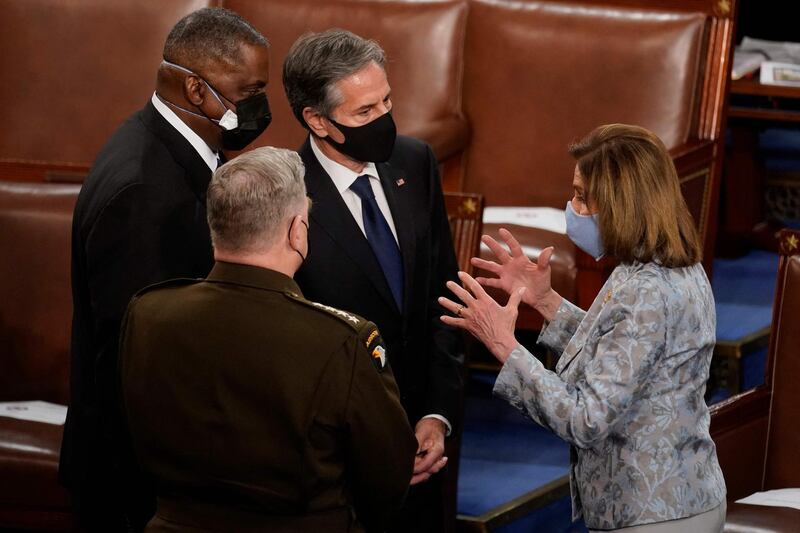 House Speaker Nancy Pelosi talks with Chairman of the Joint Chiefs of Staff General Mark Milley, Defense Secretary Lloyd Austin and Secretary of State Antony Blinken after President Joe Biden spoke to a joint session of Congress at the US Capitol in Washington, DC, on April 28, 2021. / AFP / POOL / Andrew Harnik
