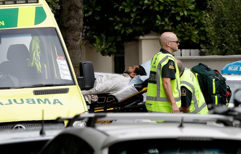 Ambulance staff take a man from outside a mosque in Christchurch. AP Photo