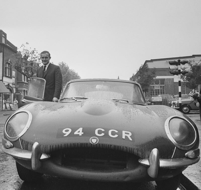 British Grand Prix motorcycle road racer Mike Hailwood (1940 - 1981) with his Jaguar E-Type sports car, Acton Lane, west London, 17th October 1963.  (Photo by Robert Stiggins/Daily Express/Hulton Archive/Getty Images)