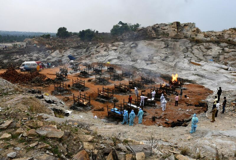 Volunteers and relatives prepare to cremate the bodies of coronavirus victims at a crematorium g in Giddenahalli village on the outskirts of Bangalore, India. Reuters