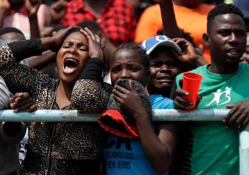 Mourners react emotionally as the coffin of former Zimbabwean President Robert Mugabe lies in state for public viewing at the Rufaro Stadium in Harare, Zimbabwe, The body is on view at the stadium for a second day. Mugabe died last week in Singapore at the age of 95. He led the southern African nation for 37 years before being forced to resign in late 2017. AP Photo