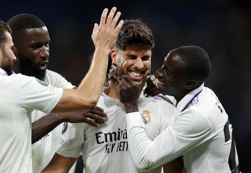 Marco Asensio celebrates with teammates after scoring for Real. Getty