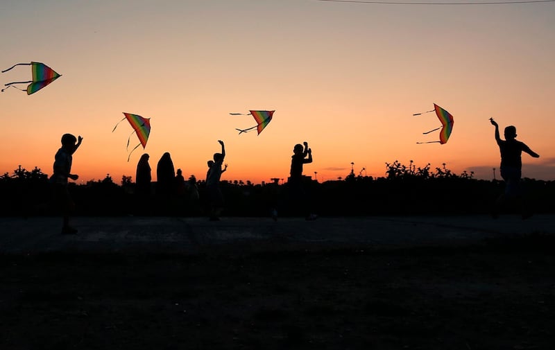 Children launch kites during Nowruz celebration as the sun sets in Baghdad, Iraq. AP Photo