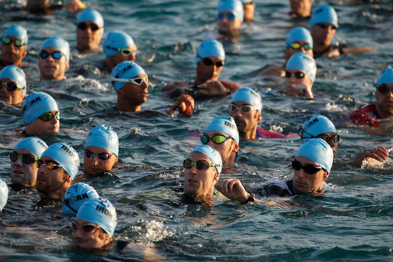 Competitors wait for the start of the swim portion of the Ironman World Championship Triathlon in Kona, Hawaii. Marco Garcia / AP Photo