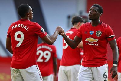 Manchester United's French striker Anthony Martial (L) celebrates scoring his team's third goal, his hatrick, with Manchester United's French midfielder Paul Pogba during the English Premier League football match between Manchester United and Sheffield United at Old Trafford in Manchester, north west England, on June 24, 2020. RESTRICTED TO EDITORIAL USE. No use with unauthorized audio, video, data, fixture lists, club/league logos or 'live' services. Online in-match use limited to 120 images. An additional 40 images may be used in extra time. No video emulation. Social media in-match use limited to 120 images. An additional 40 images may be used in extra time. No use in betting publications, games or single club/league/player publications.
 / AFP / POOL / Michael Steele / RESTRICTED TO EDITORIAL USE. No use with unauthorized audio, video, data, fixture lists, club/league logos or 'live' services. Online in-match use limited to 120 images. An additional 40 images may be used in extra time. No video emulation. Social media in-match use limited to 120 images. An additional 40 images may be used in extra time. No use in betting publications, games or single club/league/player publications.
