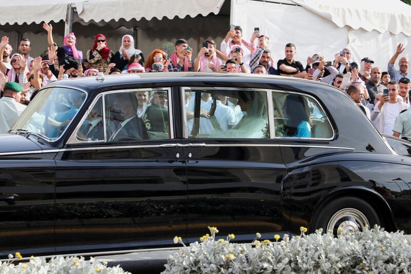 The bride waves from a car on her wedding day. Reuters