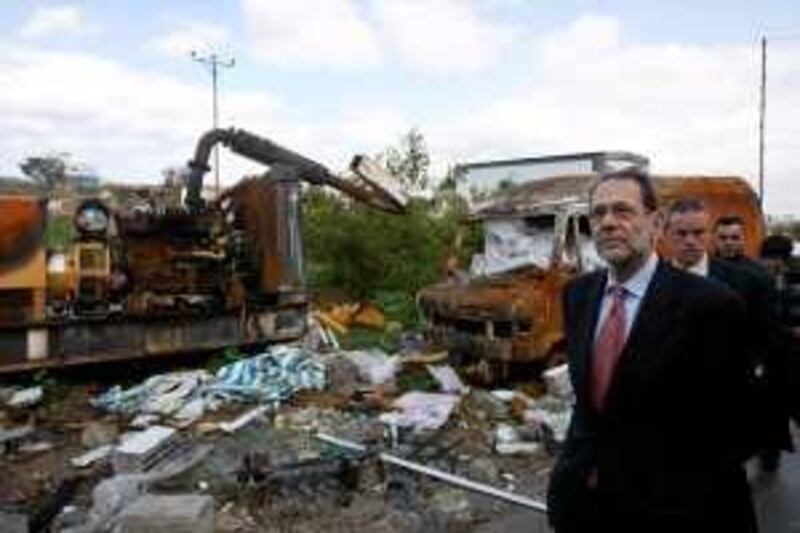 European Union foreign policy chief Javier Solana (R) inspects the damage caused during Israel's 22-day offensive at an industrial zone in Gaza City on February 27, 2009. Solana toured the war-shattered Gaza Strip, his first such trip since the Islamist Hamas seized power in the Palestinian territory in June 2007. AFP PHOTO/MAHMUD HAMS