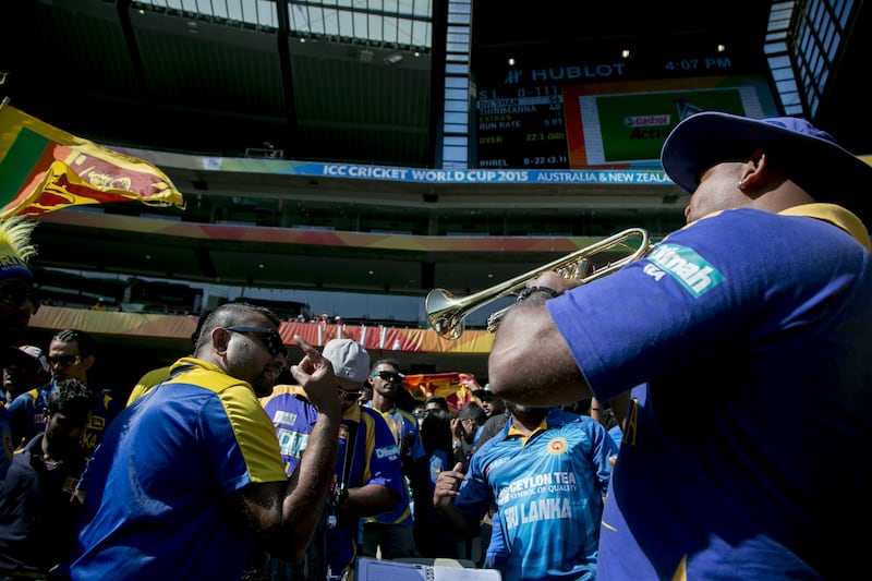 A Sri Lankan papare band sounds the trumpet as spectators dance during the 2015 ICC Cricket World Cup Pool A group match between Sri Lanka and Bangladesh at Melbourne Cricket Ground, Australia on February 26, 2015. Shutterstock