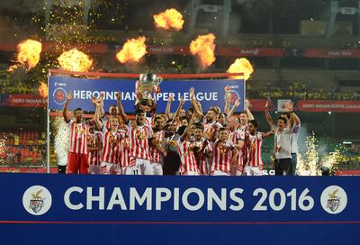 (FILES) This file photo taken on December 19, 2016 shows Atletico de Kolkata players celebrating with the trophy after winning the Indian Super League (ISL) final football match against Kerala Blasters FC at the Jawahar Lal Nehru Stadium in Kochi.
The Indian Super League has slashed the number of high-earning foreign stars for its new season starting Friday but foreign coaches, including ex-England heroes Teddy Sheringham and Steve Coppell, will be in charge of every team. / AFP PHOTO / SAJJAD HUSSAIN