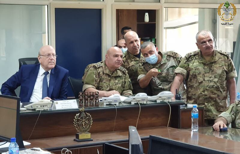 Lebanon's Prime Minister Najib Mikati, left, meeting Lebanese Armed Forces chief Joseph Aoun, centre, and military officials in Yarze, near Beirut. AFP