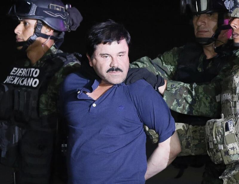 Fugitive Mexican drug lord Joaquin 'El Chapo' Guzman is escorted by the authorities to a Mexican Army helicopter in Los Mochis, Sinaloa, Mexico, on January 8, 2016. EPA