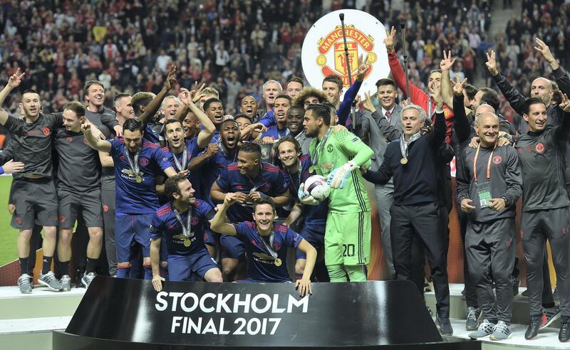 Manchester United's Portuguese manager Jose Mourinho and players pose with the trophy after during the UEFA Europa League final football match Ajax Amsterdam v Manchester United on May 24, 2017 at the Friends Arena in Solna outside Stockholm. (Photo by PAUL ELLIS / AFP)