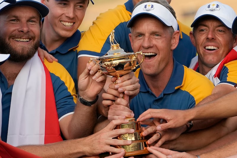 Europe's captain Luke Donald, centre, and team members lift the Ryder Cup. AP