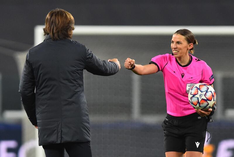 Stephanie Frappart, bumping fists with Juve manager Pirlo, became the first female to referee a men's Champions League match. Reuters