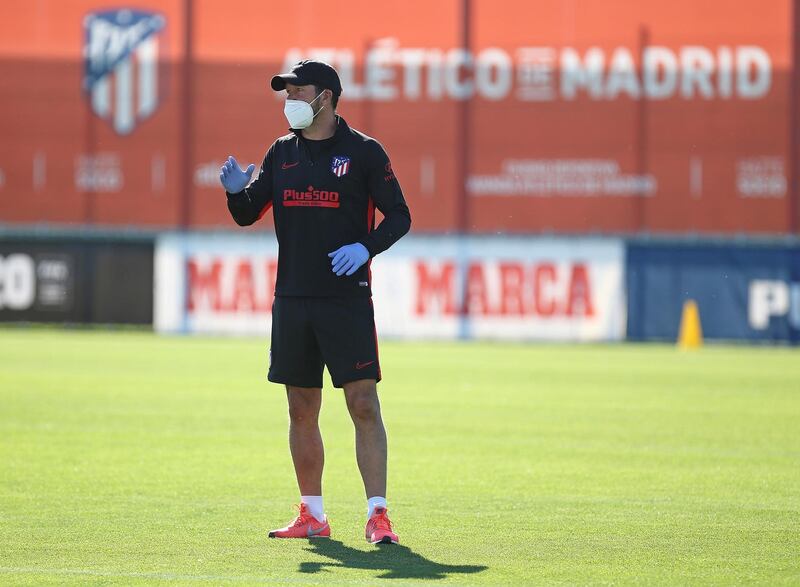 Diego Simeone wearing gloves and a protective mask during a training session at Wanda Sport City. EPA