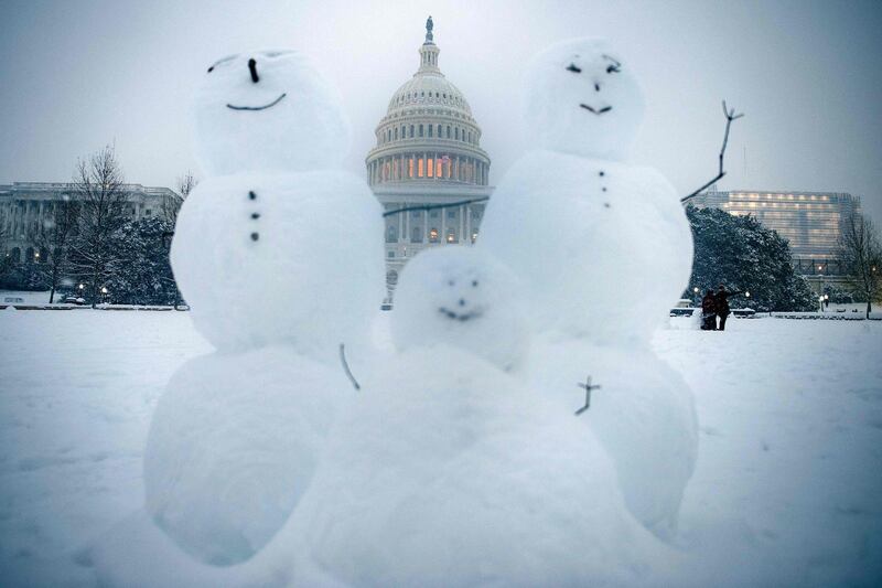 Snowmen are seen on Capitol Hill during a winter storm in Washington, DC. AFP