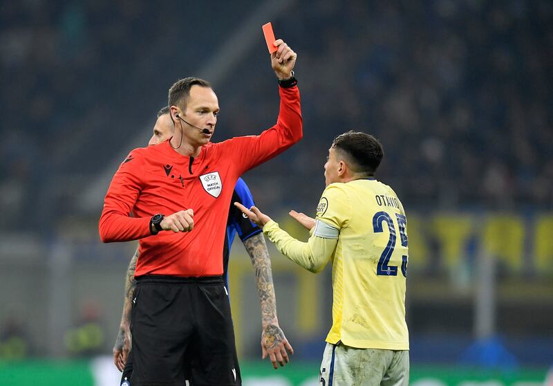 Porto's Otavio is shown a red card by referee Srdjan Jovanovic after receiving two yellows. Reuters