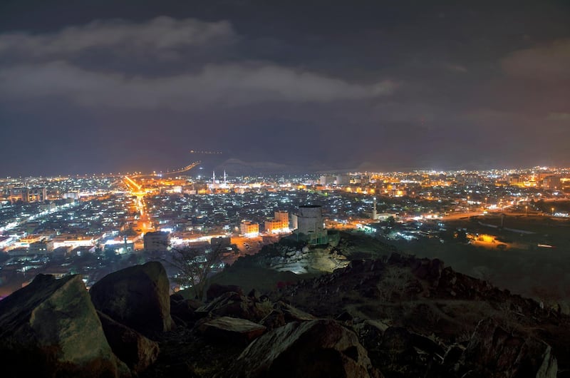 Khor Fakkan town at night with a historic fort pictured in the foreground. Courtesy: Sharjah Government / Wam