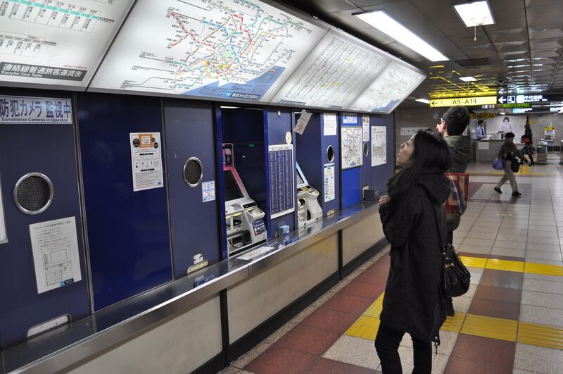 A woman checking the map at a Metro station in Tokyo (Photo by Rosemary Behan)