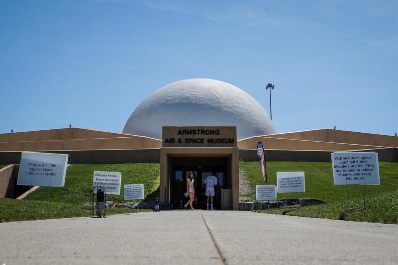 Visitors linger outside the Armstrong Air & Space Museum in Wapakoneta, Ohio. All photos by AP Photo