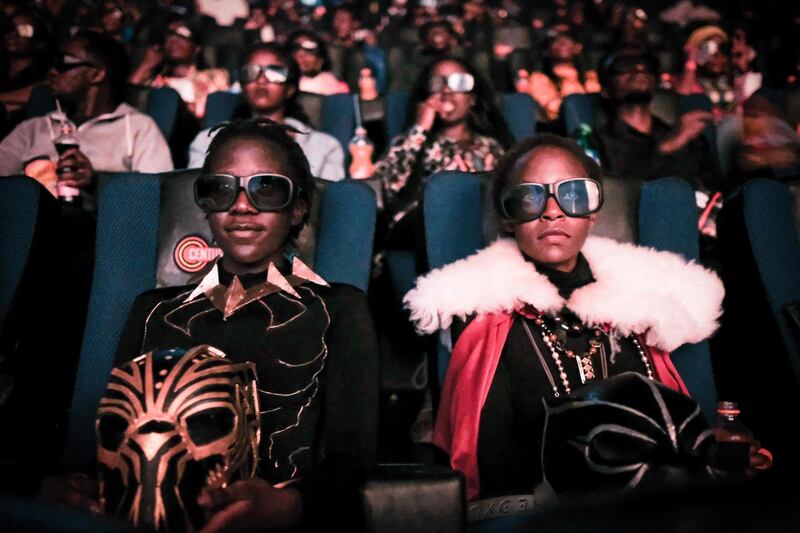 Cosplayers watches the film "Black Panther" in 3D which featuring Oscar-winning Mexico born Kenyan actress Lupita Nyong’o during Movie Jabber’s Black Panther Cosplay Screening in Nairobi, Kenya, on February 14, 2018.
Black Panther is a Superhero film based on the Marvel Comics character featured the first black superhero as Black Panther in advanced fictional African nation. Nyong’o who won the Academy Award for best supporting actress in 12 Years a Slave in 2014, plays a major role as a female warrior in the film.  / AFP PHOTO / Yasuyoshi CHIBA