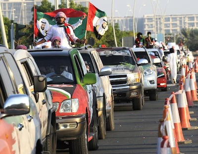 People take part in a parade as part of UAE National Day celebrations in Abu Dhabi in 2013. Charles Crowell for The National  