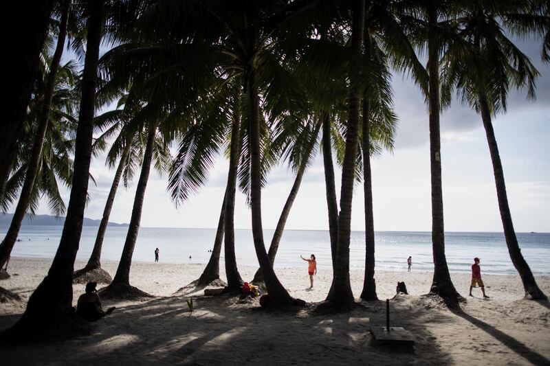 Tourists visit the beach on Boracay. AFP