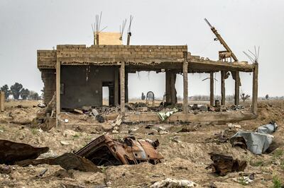 The house of local farmer Hamad al-Ibrahim is seen destroyed in the eastern Syrian village of Baghouz on March 13, 2020, a year after the fall of the Islamic State's (IS) caliphate. - A year after the last black flag of the Islamic State group was lowered in the Syrian village of Baghouz, traces of the jihadist group are still all around this small and remote village near the Iraqi border, where Kurdish fighters and the US-led coalition declared the IS proto-state defeated in March 2019 after a blistering months-long assault. (Photo by DELIL SOULEIMAN / AFP)