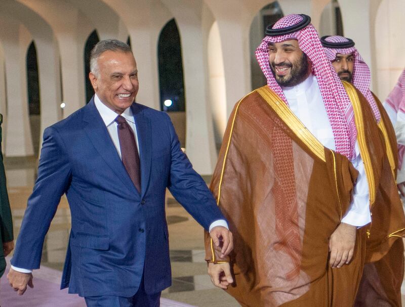 Saudi Crown Prince Mohammed bin Salman accompanies Iraqi Prime Minister Mustafa Al Kadhimi, upon his arrival at King Abdulaziz International Airport in Jeddah. Saudi Royal Palace/AP