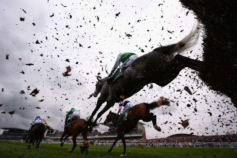 Horses jump a fence during the Manifesto Novices’ Steeple Chase at Aintree Racecourse in Liverpool, England. Alex Livesey / Getty Images / April 6, 2017