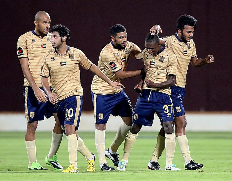 Gilles Yapi-Yapo, second from the right, and his Dubai teammates celebrate after scoring against Al Jazira during an Arabian Gulf League match at the Al Nahyan Stadium in Abu Dhabi. The match ended 2-2. Satish Kumar / The National