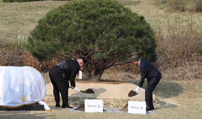 North Korean leader Kim Jong Un, left, and South Korean President Moon Jae-in plant a pine tree near the military demarcation line at the border village of Panmunjom in the Demilitarized Zone, South Korea, Friday, April 27, 2018. North Korean leader Kim made history by crossing over the world's most heavily armed border to greet South Korean President Moon for talks on North Korea's nuclear weapons. (Korea Summit Press Pool via AP)