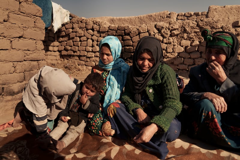 Aziz Gul, second from right, and her 10-year-old daughter Qandi, centre, outside their home with other family members, near Hera.  Qandi's father sold her into marriage without telling his wife, Aziz, taking a down-payment so he could feed his family. AP Photo