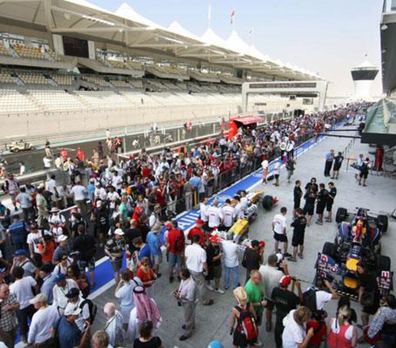 Fans fill the pit lane as ticket holders get their first chance to see the track yesterday.