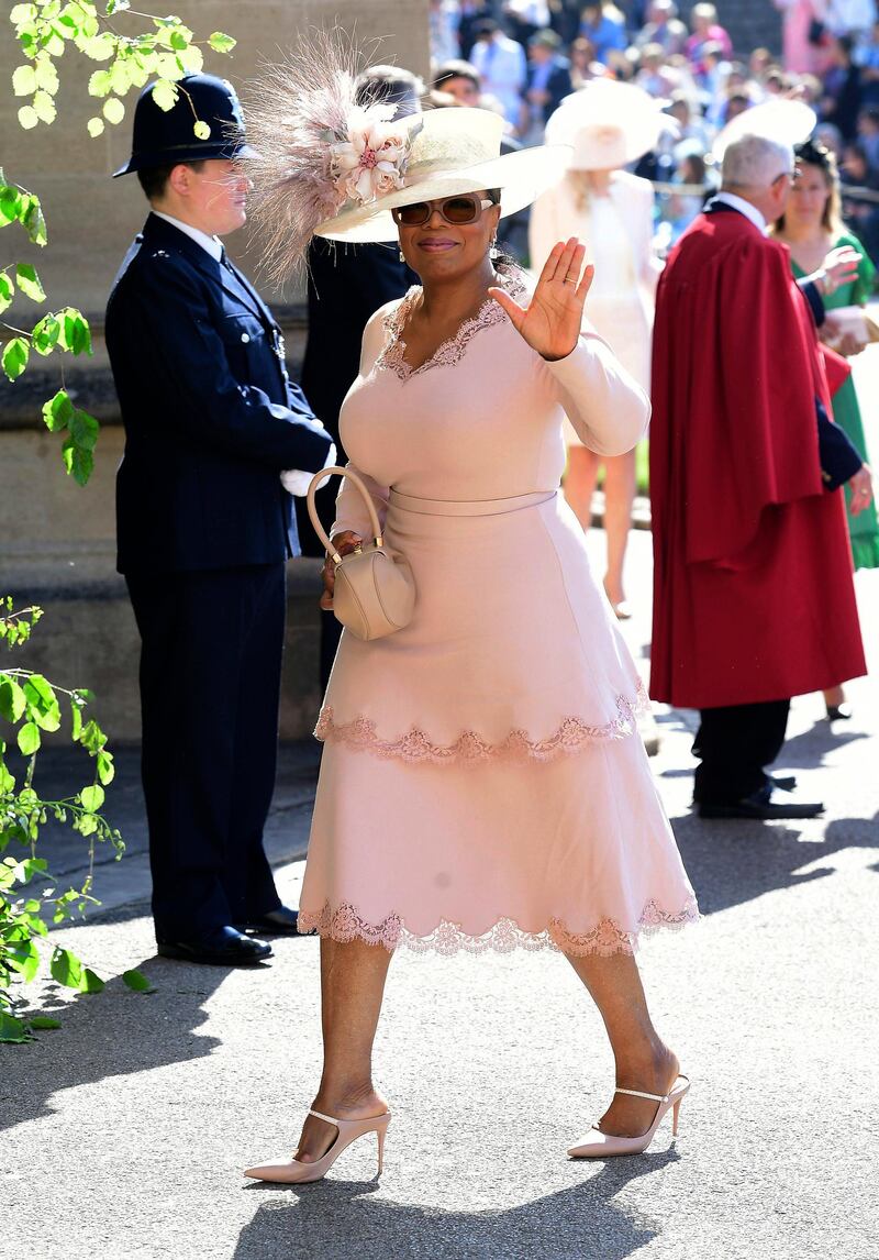 Oprah Winfrey waves as she arrives at St George's Chapel at Windsor Castle the wedding ceremony of Prince Harry and Meghan Markle at St. George's Chapel in Windsor Castle in Windsor. Ian West / AP Photo