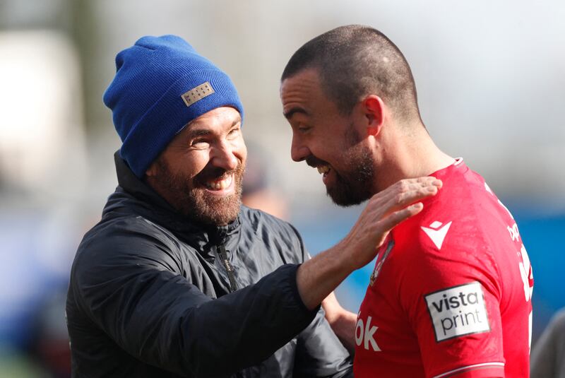 Wrexham's Ollie Palmer with co-owner Ryan Reynolds, left, after a 3-2 win over Notts County pushed the Welsh club closer to promotion to a return to the fourth tier of English football. Reuters