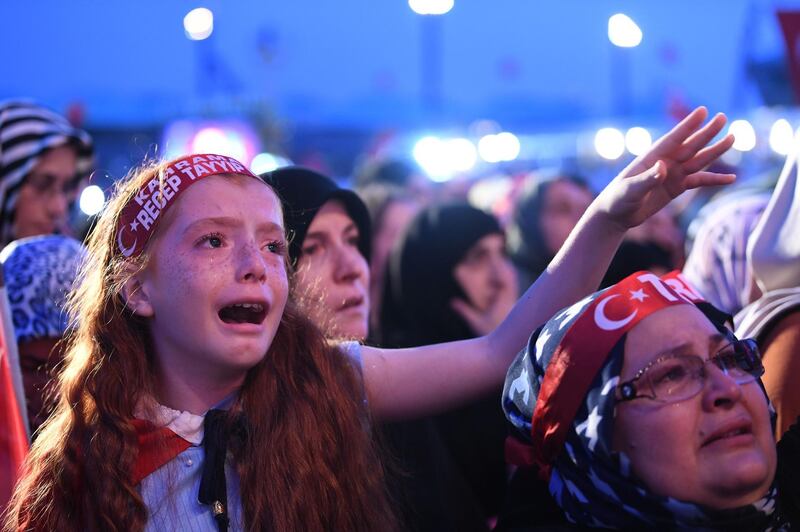 A girl cries as a Turkish crowd chants the names of people who were killed during a coup attempt at the Ataturk International Airport in Istanbul on July 15 2016. AFP