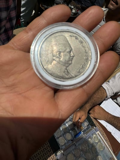 A coin minted in 1923 during King Fuad I's rule on sale at Cairo's Diana Market. Kamal Tabikha / The National