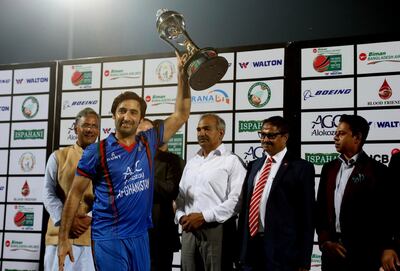 Afghanistan captain Asghar Stanikzai collects the winning trophy after winning the final day of T20 cricket match between Afghanistan and Bangladesh in Dehraduni, India, Friday, June 8, 2018, Afghanistan win the series by 3-0. (AP Photo/Anupam Nath)