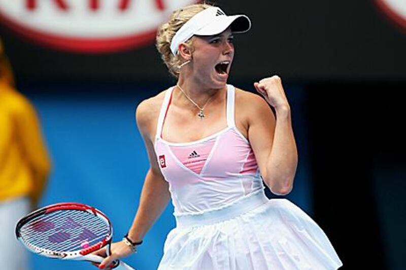 Caroline Wozniacki clenches her fist after battling back to beat Fracesca Schiavone.