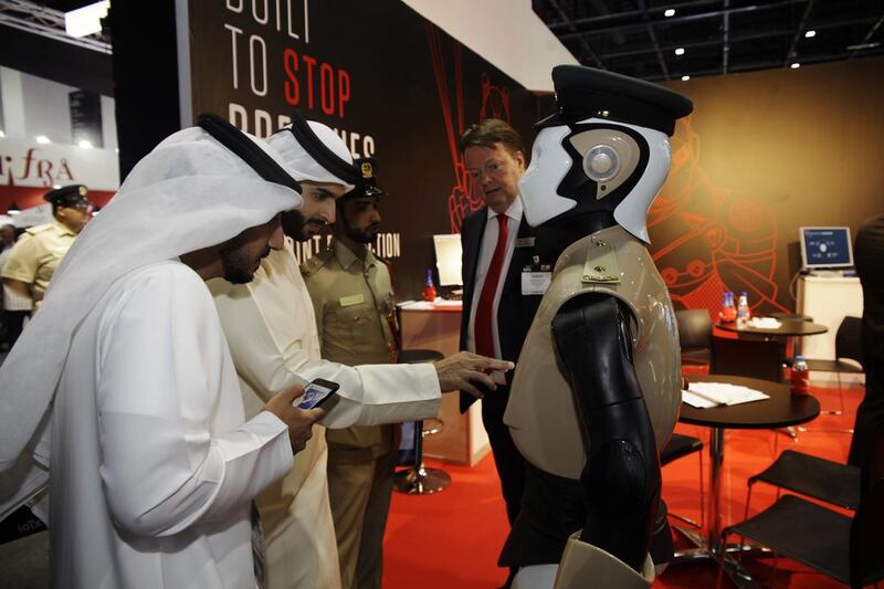Visitors to the Gulf Information & Security Expo and Conference get acquainted with Dubai’s Robocop. Anna Nielsen for The National